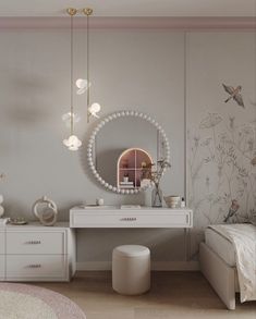 a bedroom with white furniture and flowers on the wall behind the bed, along with a round mirror hanging from the ceiling