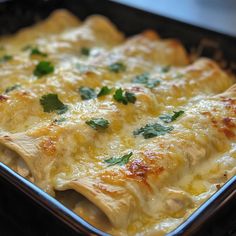 a casserole dish with cheese and parsley