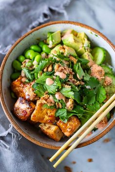 This vegan Tofu Bowl is full of protein and bursting with flavor! Made with sushi rice, edamame, cucumber, avocado, and our sticky glazed tofu, topped with crispy onions and cilantro, drizzled with vegan yum yum sauce! Gluten-free.