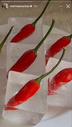 three pieces of ice with chili peppers on them sitting on a plate next to each other