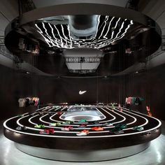 a large circular room with clothes hanging from the ceiling