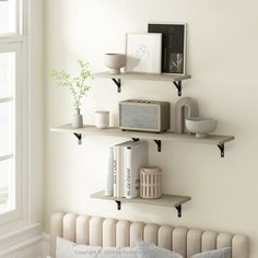 three shelves on the wall above a bed