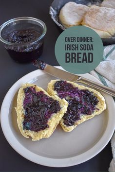 two pieces of bread with blueberry jam on them next to a bowl of jelly