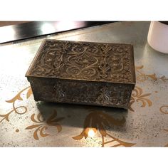 an ornate wooden box sitting on top of a table