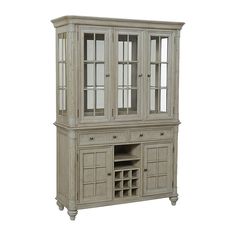 a white china cabinet with glass doors and drawers on the bottom shelf, in front of a white background