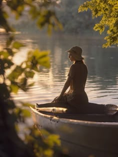 a woman is sitting in a boat on the water