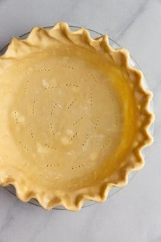 a pie crust in a pie pan with the words tender & flaky pie crust