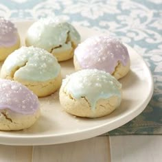 a white plate topped with cookies covered in frosting