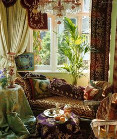 a living room filled with furniture and a chandelier hanging from the ceiling next to a window