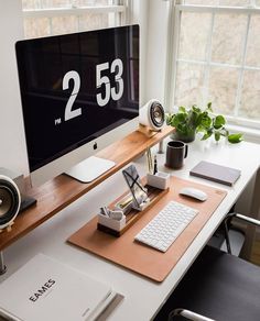 a desk with a computer and speakers on it