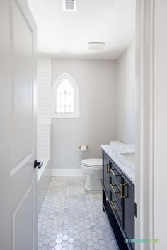 a bathroom with a toilet, sink and window