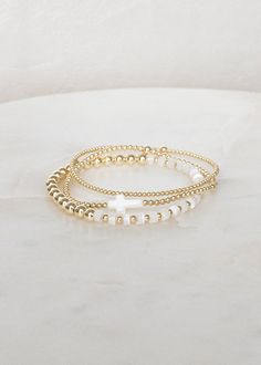 "❖Radiance Stack❖ * An elevated stack of everyday bracelets!  ‣ This listing offers the option of purchasing the stack of 3, or individual bracelets. ‣ Buy more, save more - applied at checkout      * 3 10% off      * 5, 15% off      * 7, 20% off ‣ Radiance Stack features 3 bracelets: * Britt - Mother of Pearl * Wren - Mother of Pearl Cross * Myla 2mm - 14k Gold Filled Julisa Bracelets Feature:  ‣ Tight/Sturdy elastic, pre-stretched to prevent bracelet from stretching out ‣ Sizing according to wrist size ‣Sizing Tips:  Please measure your wrist for the best fit!  *Using a soft tape measure/string, measure around your wrist, above the wrist bone *Add length according to your desired fit:       * 0\" - fitted, snug      * .25\" - slight movement      * .5\" -  comfortable movement      * .75 Wwjd Bracelet Stack, Preppy Gold Bracelet Stack, Gold Filled Bracelet Stack, Christian Bracelet Stack, Gold Stacking Bracelets, Thing To Add To Your Christmas List, Enewton Bracelets Stacks Aesthetic, Gold Bracket Stack, Gold Filled Beaded Bracelets