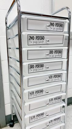 a metal filing cart with seven drawers on each side, labeled 2nd period and 3rd period