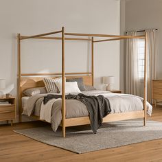 a bedroom with white walls and wooden furniture