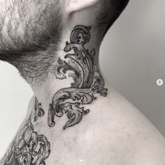 a man with a tattoo on his neck