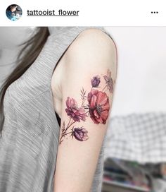 a woman with a flower tattoo on her arm