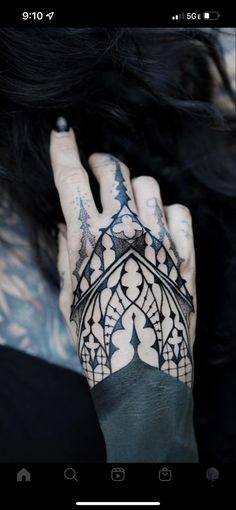 a woman's hand with tattoos on it