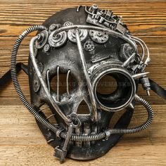 a metal mask with gears attached to it