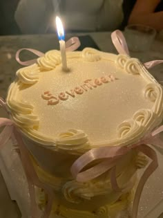 a birthday cake with a lit candle on it that says severmez in frosting