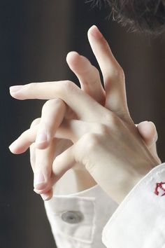 a close up of a person holding their hand out to the side with both hands