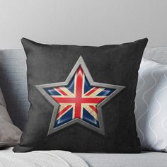 a star with the british flag on it is sitting on top of a couch throw pillow