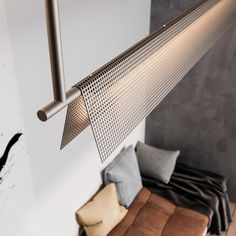 a metal lamp hanging from the ceiling in a living room