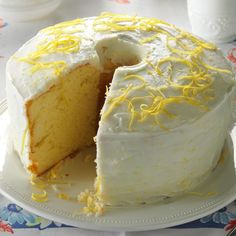 a white cake with yellow icing on a plate