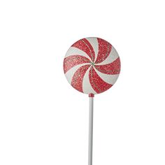 a red and white lollipop on a stick