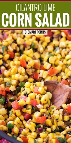 corn salad in a skillet with a wooden spoon on the side and text overlay that reads, cilantro lime corn salad 0 smart points