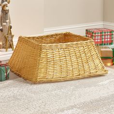 a wicker basket sitting on the floor next to presents