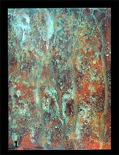 an old rusted metal surface with some paint on it