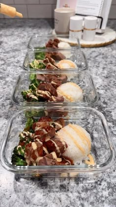 three plastic containers filled with food on top of a counter