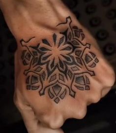 a person's hand with a tattoo on it