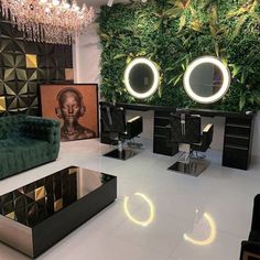 a room filled with furniture and mirrors in front of a wall covered in greenery