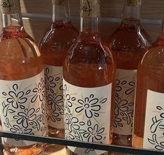 several bottles of wine sitting on a shelf