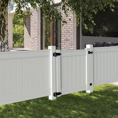 a white vinyl fence with black hardware on it