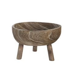 a wooden bowl sitting on top of a table