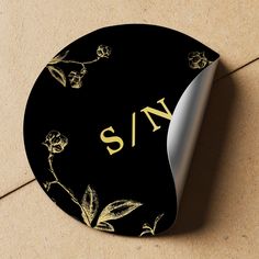 Moody black and faux gold classy vintage antique romantic style monogrammed wedding personalized seal sticker with botanical foliage branches and elegant classic typography script. Perfect to be used as an invitation envelope seal or as a favor gift packaging label.