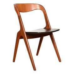 a wooden chair sitting on top of a white floor next to a black leather seat