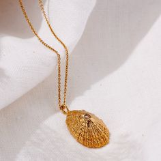 The little Limpet shell is found on beaches all over the world and is sure to evoke warm memories to the wearer. A handful of beachcombed shells nearly always has several Limpet shells. We have elevated this pretty shell by hand making it in 18ct yellow gold plated sterling silver which highlights it's shape and sand worn textures. Jewellers in our Brighton seaside studio handmake each Yellow Gold Plated Limpet Shell Necklace. Wear the Posh Totty Designs Personalised Limpet Shell Necklace, and r Gold Coastal Jewelry Gift, Limpet Shell, Posh Totty, Luxury Scarves, Hand Making, Artisan Gift, Patchwork Print, Shell Necklace, Mens Jewelry Bracelet