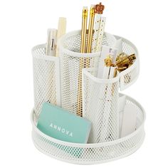 a white desk organizer with pens and pencils