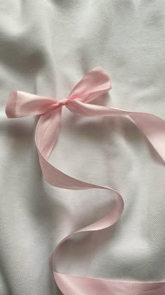 pink satin ribbon on white fabric