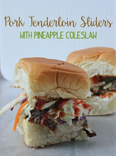 two pork tenderloin sliders with pineapple coleslaw on a marble surface