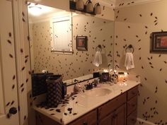 the bathroom is decorated in black and white with lots of bats on the wall above the sink