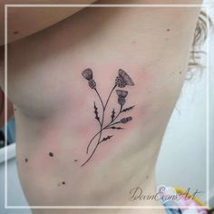 a woman's chest with some flowers on it