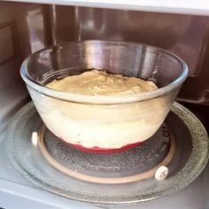 a bowl filled with batter sitting on top of an oven