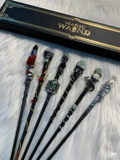 six harry potter wands are in a box