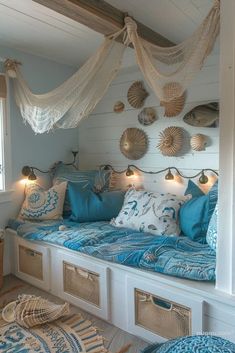 a bed with lots of pillows on top of it and some lights hanging from the ceiling