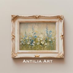 an art piece hanging on the wall above it is a painting with blue and white flowers