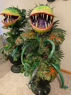 two fake plants with mouths and teeth on them